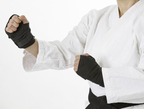 Woman hands wrap in black boxing strap, in fighting stance