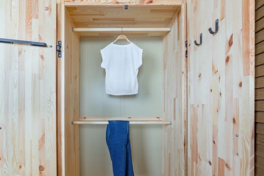 shirt and pants in wooden wardrobe