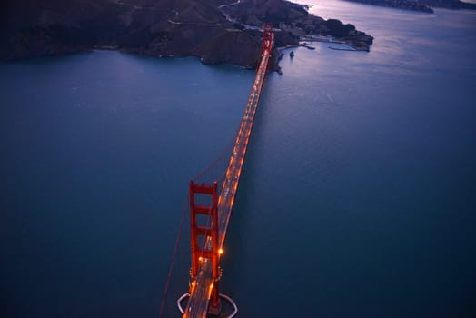 an aerial view of golden gate bridge in san francisco during sunset, taken from a helicopter