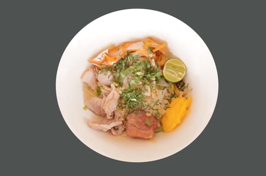 Delicious rice noodles with pork close-up on a plate