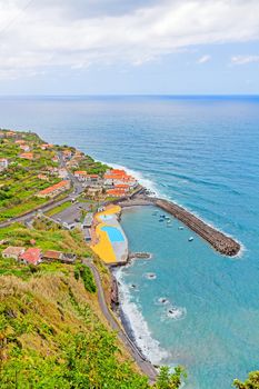 Ponta Delgada, Madeira - June 7, 2013: Eastern part of the village stretching into Atlantic Ocean - swimming bath in the foreground.