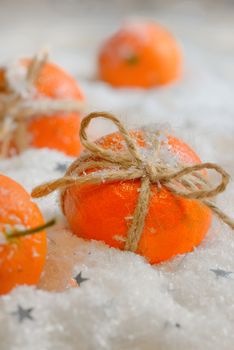 Holidays with ripe tangerines in snow