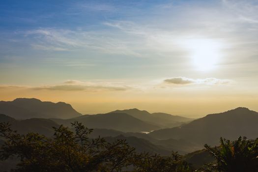 sunrise over mountains under mist in the morning at Khao Kho National Park, Phetchabun province, Thailand, wide angle view