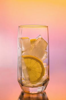 Soft drink in a glass on a colored background