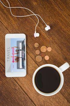 View of a white smartphone with a cup of coffee against holidays booking app