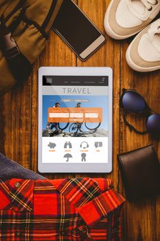 Tablet shirt jean shoes smartphone wallet and bag  against holidays booking app