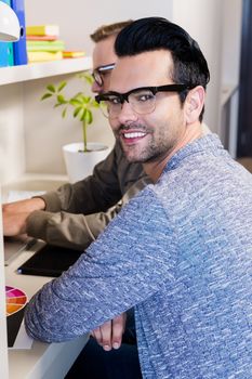 Happy gay couple working together in office