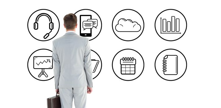 Businessman holding his briefcase against telephone apps icons 