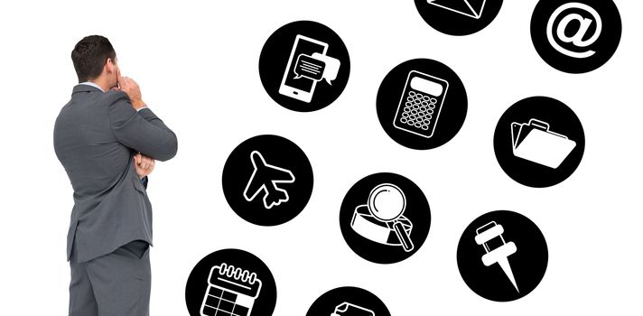 Thinking businessman against telephone apps icons 