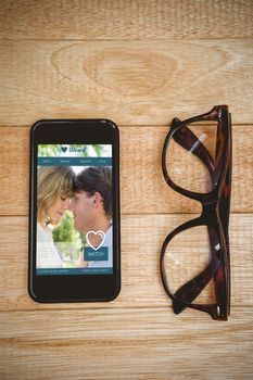 Dating website against view of glasses and a smartphone