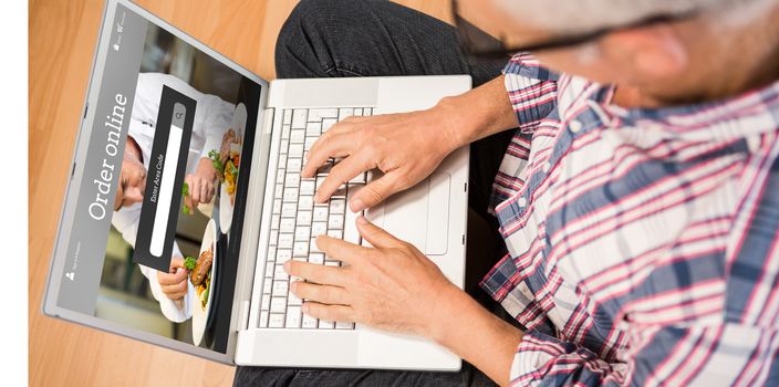Man using laptop while sitting on floor at home against food app