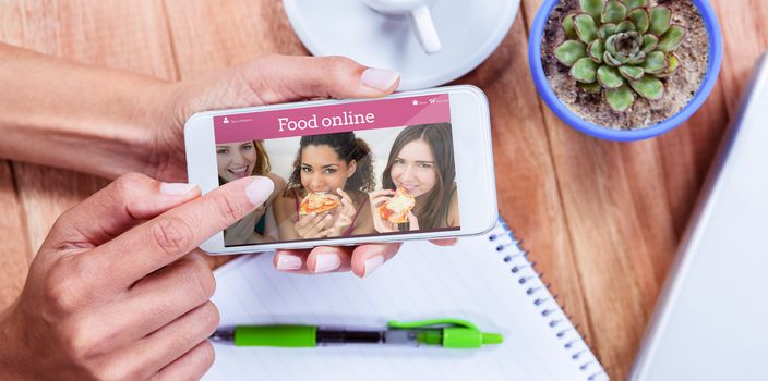 Overhead of feminine hands using smartphone against food app