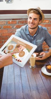 Waitress taking handsome hipsters order with tablet against food app