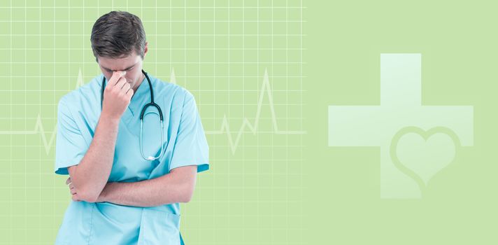 Male doctor suffering from headache against green background