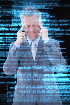 Businessman with headache against shiny blue coding on black background