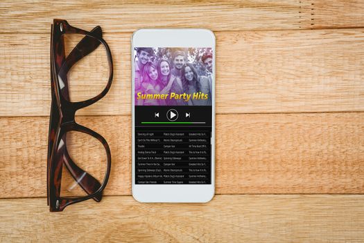 Music app against view of glasses and a smartphone