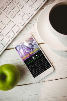 Music app against smartphone on desk