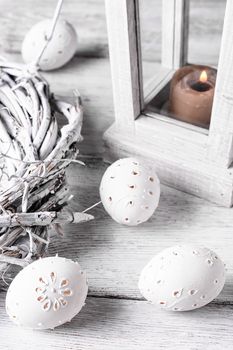 Easter eggs with cut out pattern by hand on light background.The photograph high key.