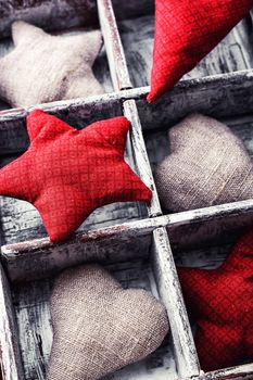 box with subdivisions filled with fabric hearts and stars.