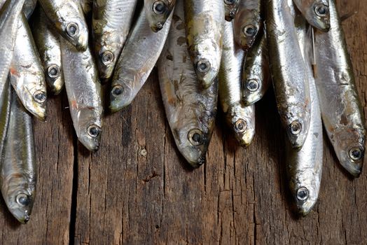 Anchovies (hamsi) on old table wood