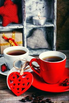 Coffee mug with tied wooden hearts for Valentine's day.Selective focus