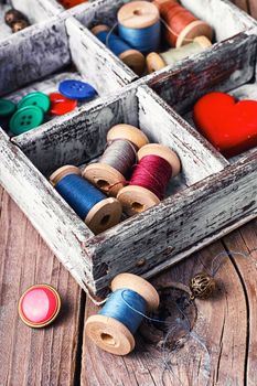 Wooden sewing box with threads,buttons and symbolic heart