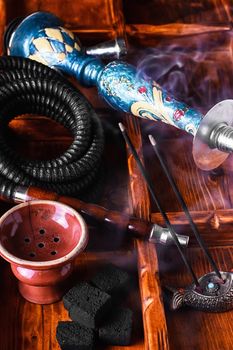 Dismantled parts of hookah on wooden background 