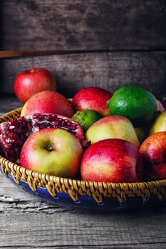 harvest of apples,lime,pomegranate and clove on a stylish plate