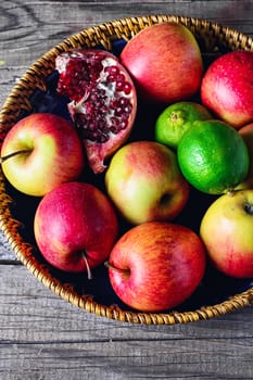 harvest of apples,lime,pomegranate and clove on a stylish plate