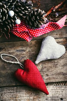 Two symbolic tissue of the heart has festive wreath with pine cones