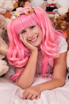 young girl in a bedroom in a pink cute dress