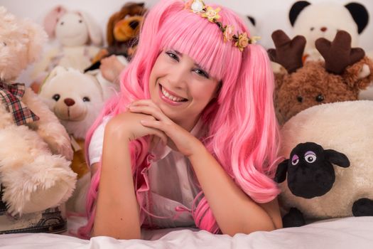 young girl in a bedroom in a pink cute dress