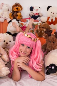 young girl in a bedroom in a pink cute dress