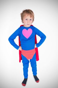 heart against portrait of boy dressed as superhero