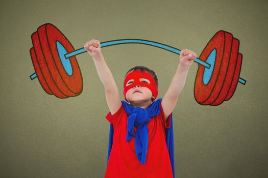 Little boy holding dumbbell against grey