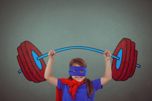 Little girl holding dumbbell against grey