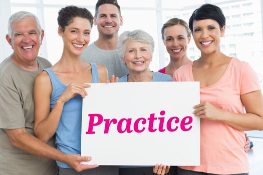 The word practice and fit people holding blank board in yoga class against room with wooden floor