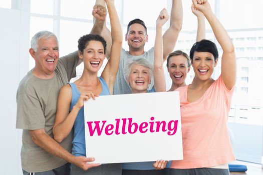 The word wellbeing and portrait of happy fit people holding blank board against grey wall