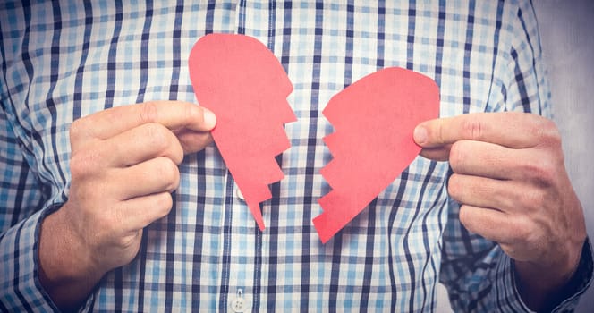 Sad man with broken heart against white background