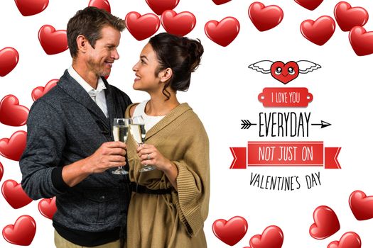 Happy romantic couple with champagne flute against cute valentines message