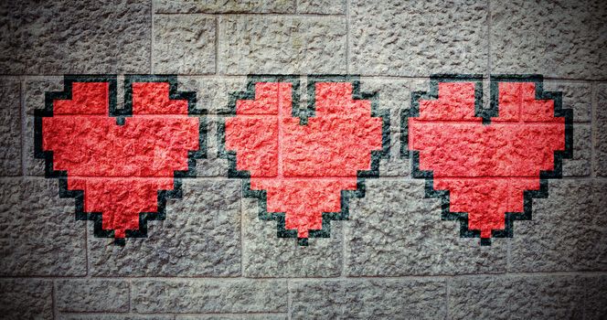 heart against grey brick wall