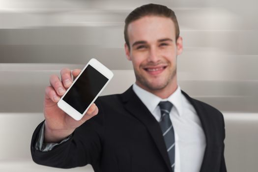 Smiling businessman showing his smartphone screen against abstract white design