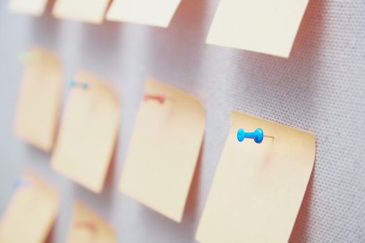 Sticky notes on a bulletin board. Close-up view