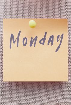 Adhesive note with Monday text on a bulletin board