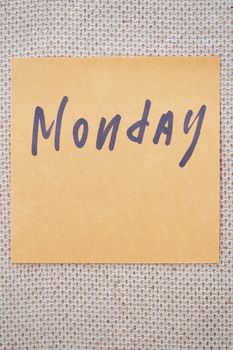 Adhesive note with Monday text on a bulletin board