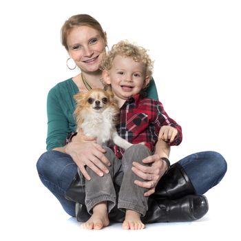 little boy, dog and mother in front of white background