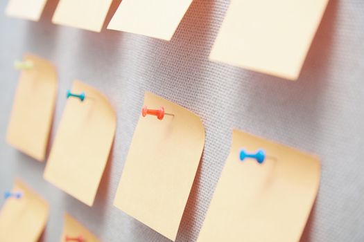 Sticky notes on a bulletin board. Close-up view