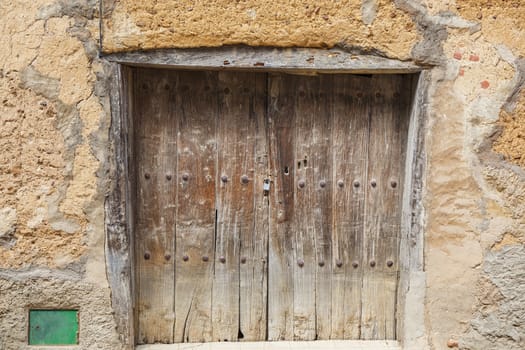 Old rustic wall with wooden textured door 