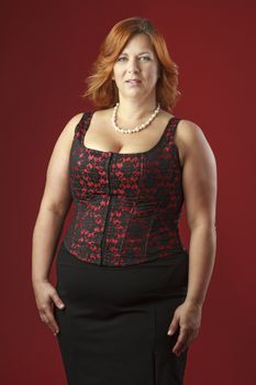 Woman in her fortie wearing a red corset