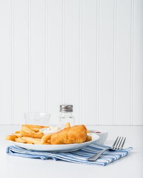 Batter and deep fried fish served with chips.